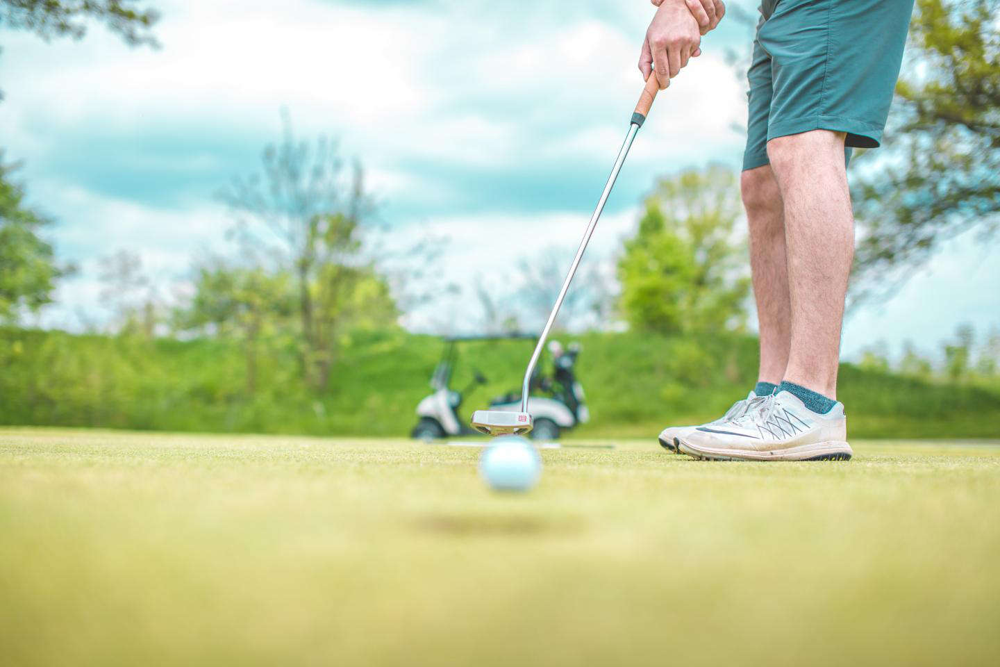 Golfer putting on a green