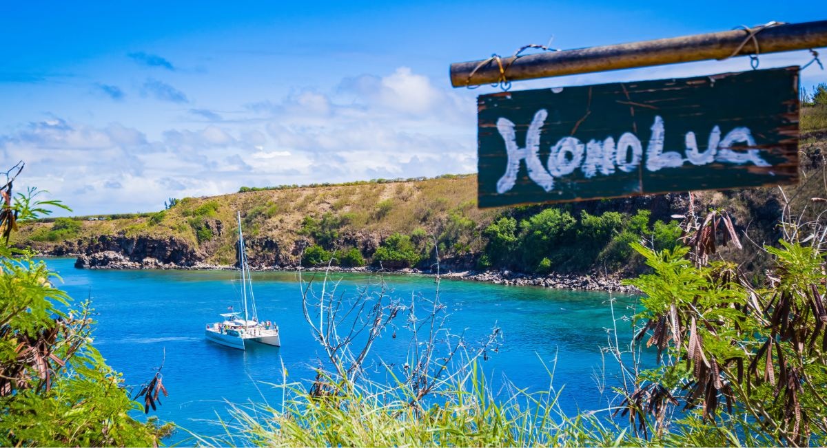 A catamaran anchored in Honolua Bay, Maui, on a calm September morning, a Marine Life Conservation District known for exceptional snorkeling visibility