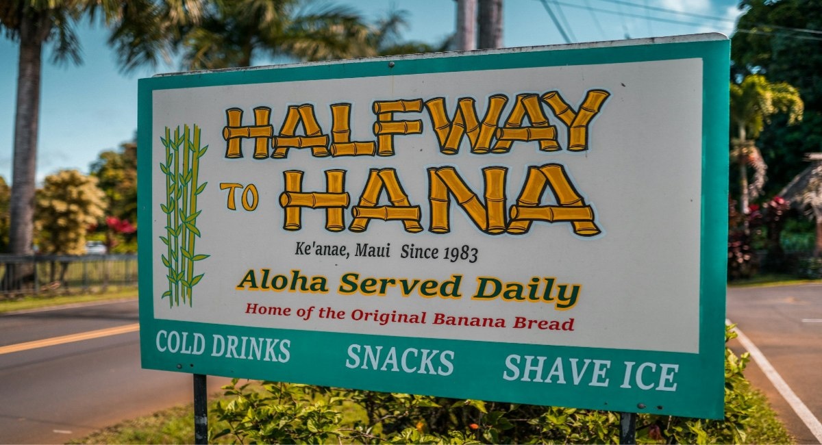 Halfway to Hāna roadside stand sign advertising original banana bread, cold drinks, and shave ice