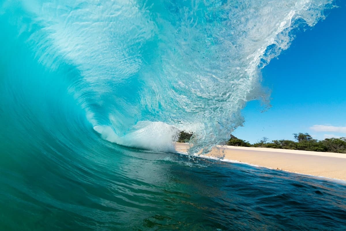 Large wave crashing onto the shore at Mākena Beach in Maui
