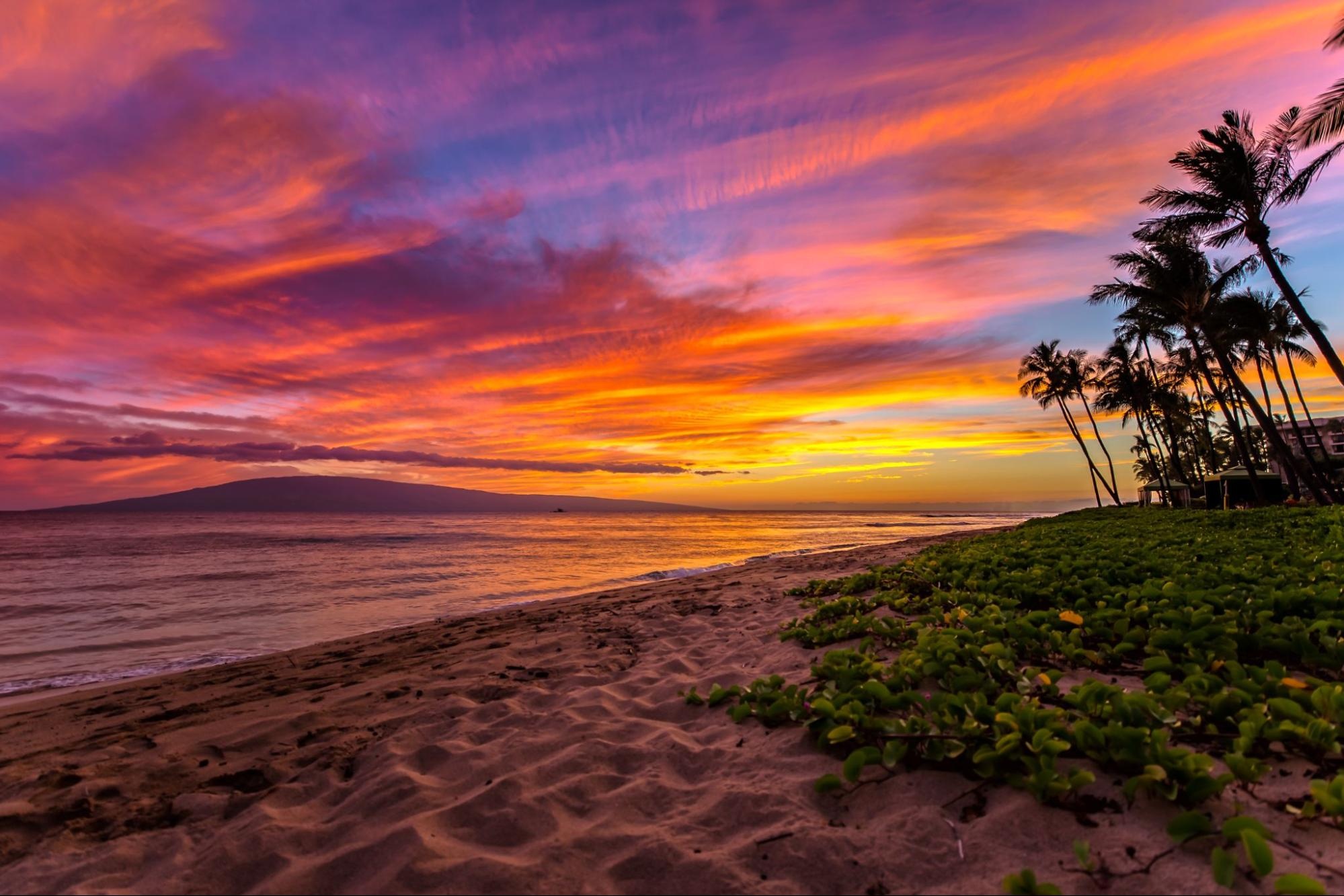 Stunning sunset over Kāʻanapali Beach with vibrant sky colors.