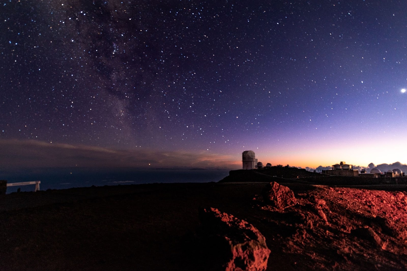Colourful starry night scene at Haleakalā Volcano Summit Observatory